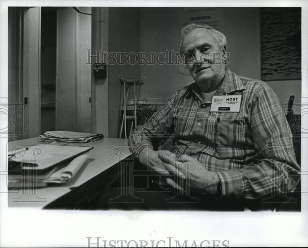 1992 Bob Vance sitting at his desk at shelter waiting for transients - Historic Images