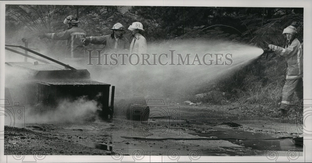 1991, Fireman sprays water on burning tar kettle, Birmingham - Historic Images