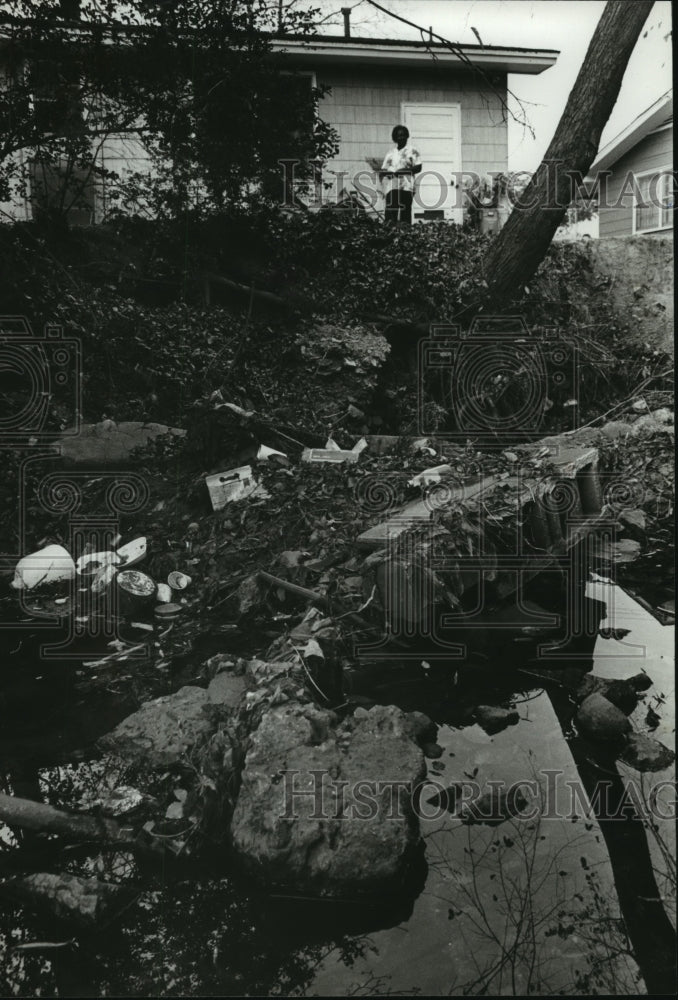 1978, Mrs. Ella Murdock views the ditch behind house in Titusville - Historic Images