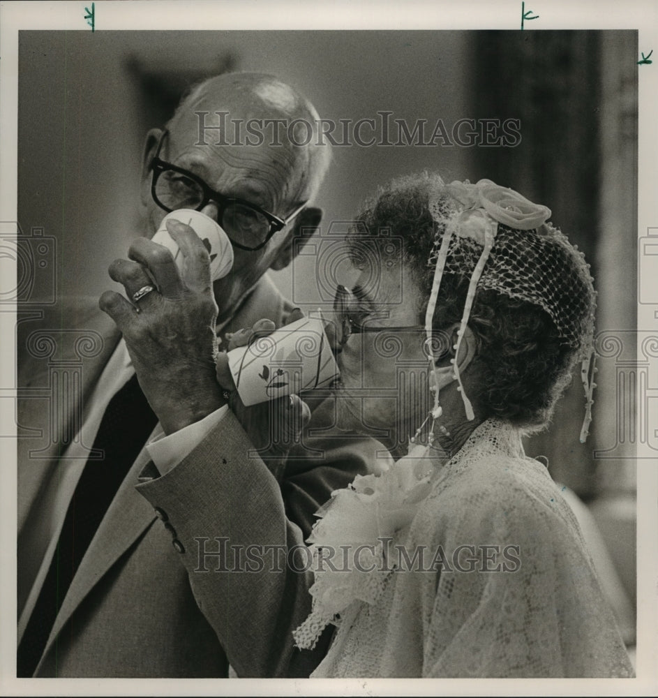 1986, Edward and Vera Carmichael, 80 year old newly weds toasts - Historic Images