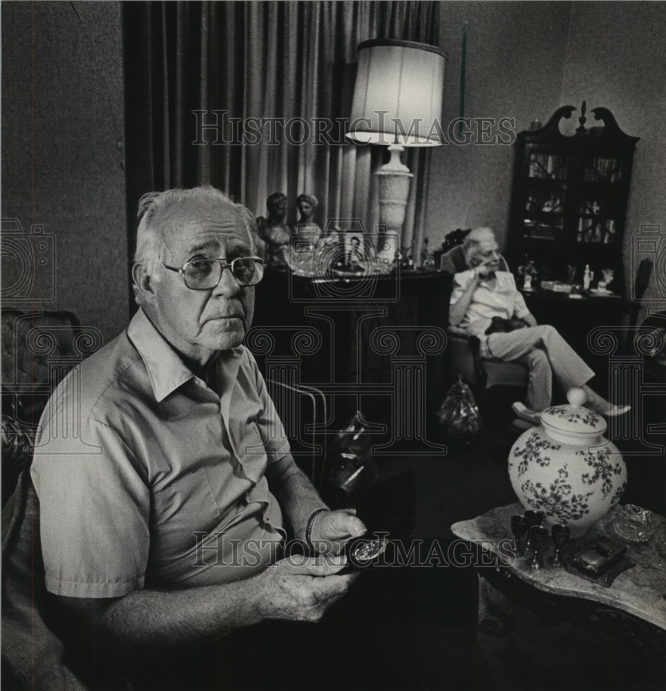 1984 Retired officer Howell Carroll holds "retired" badge, Alabama - Historic Images