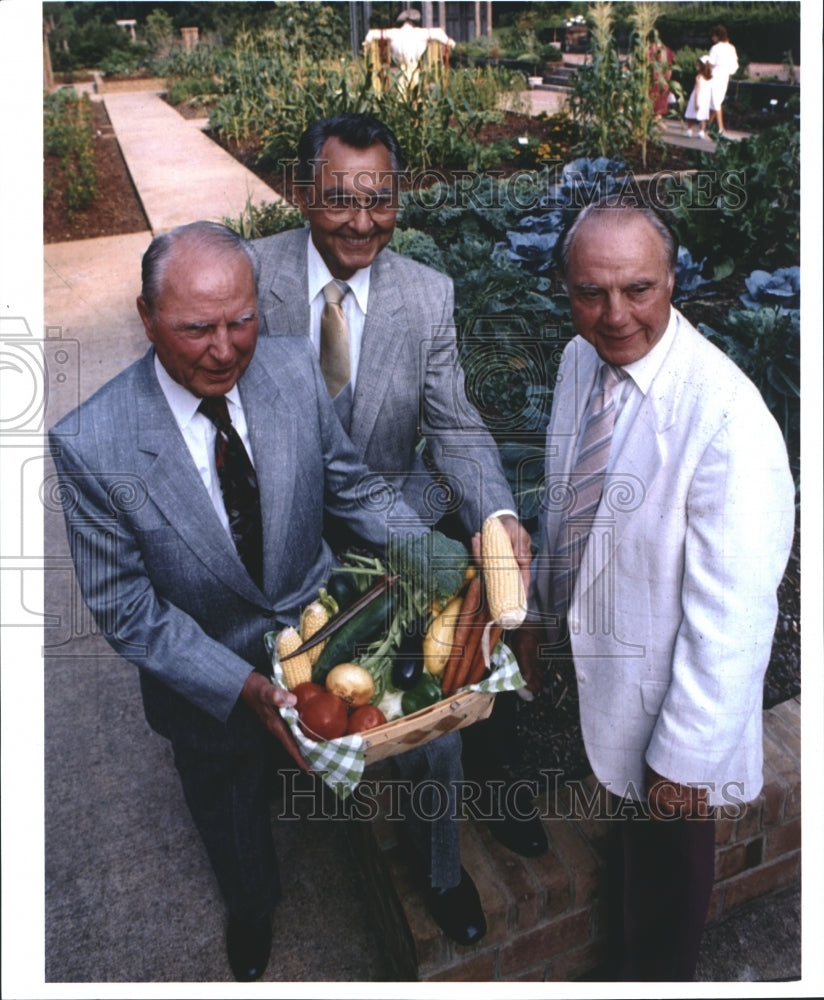 Press Photo Group of 3 Men Stand in Garden Holding Produce - abna24582 - Historic Images