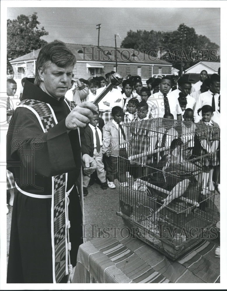 1992, Father Danielewicz Blesses Birds at Holy Family School - Historic Images