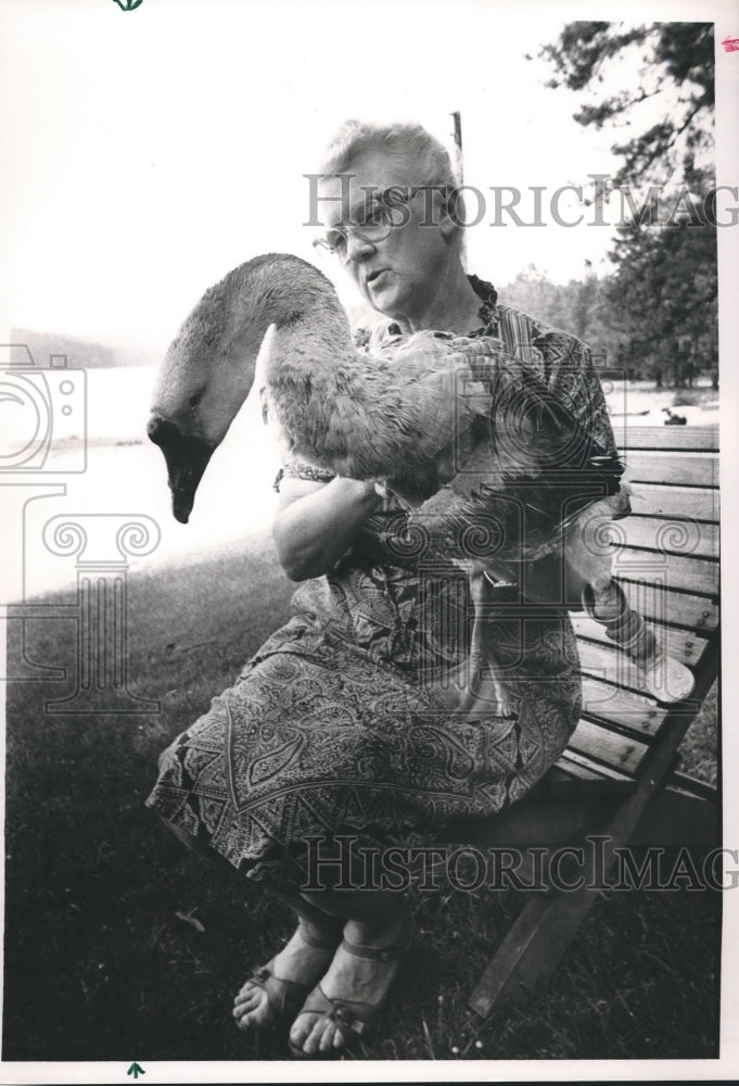 1988 Hilda Lowe holds large goose at Lake Purdy boat landing. - Historic Images