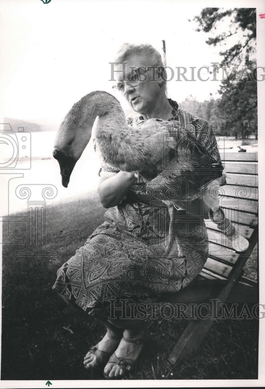 1988 Hilda Lowe holds large goose at Lake Purdy boat landing. - Historic Images