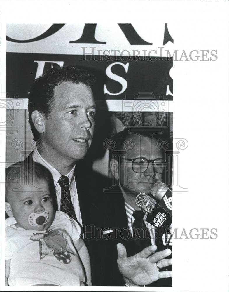 1992, Republican party chairman, Marty Connors holds baby with press - Historic Images