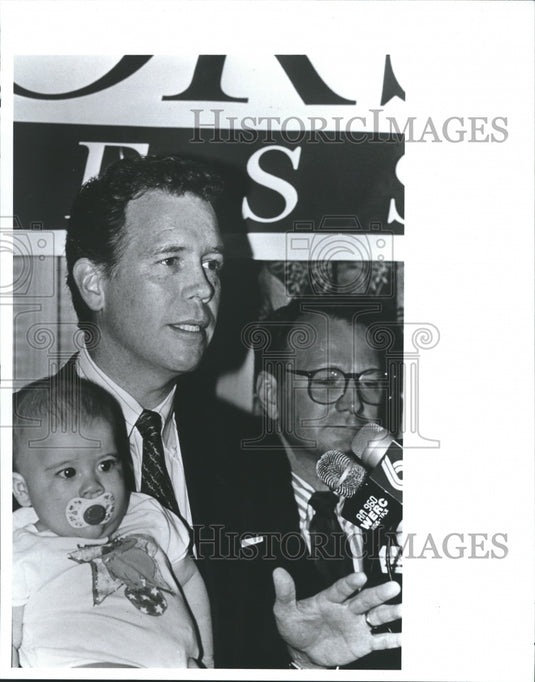 1992, Republican party chairman, Marty Connors holds baby with press - Historic Images