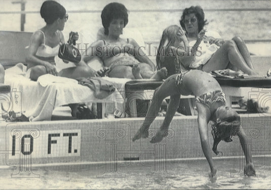 1972, Lee Wallace does back dive into Sheraton Hotel pool in Miami - Historic Images