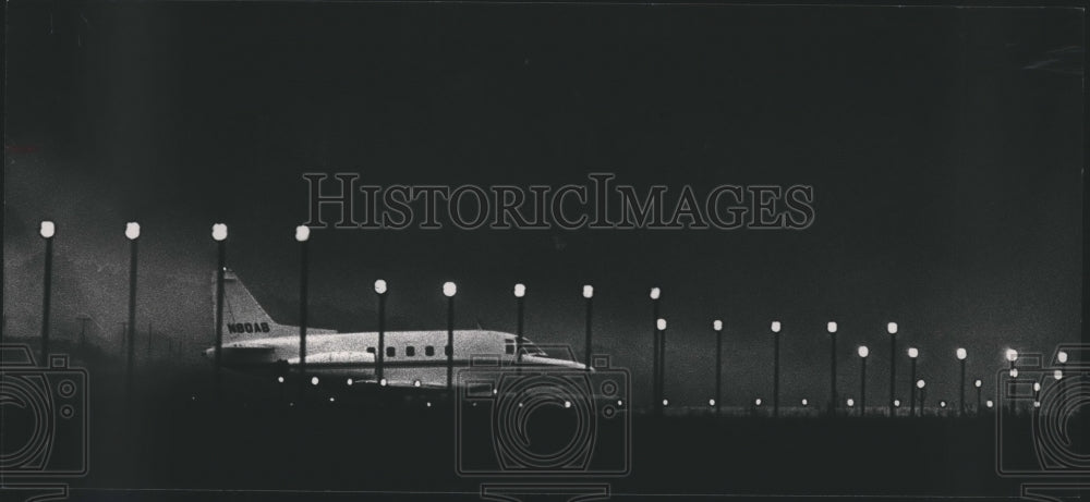 1989, Aircraft shadowed behind lights at Birmingham airport, Alabama - Historic Images