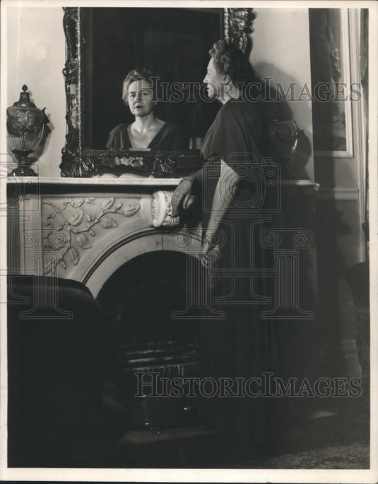 1947, Mrs. Herbert Warner looks in mirror in Tuscaloosa, Alabama - Historic Images