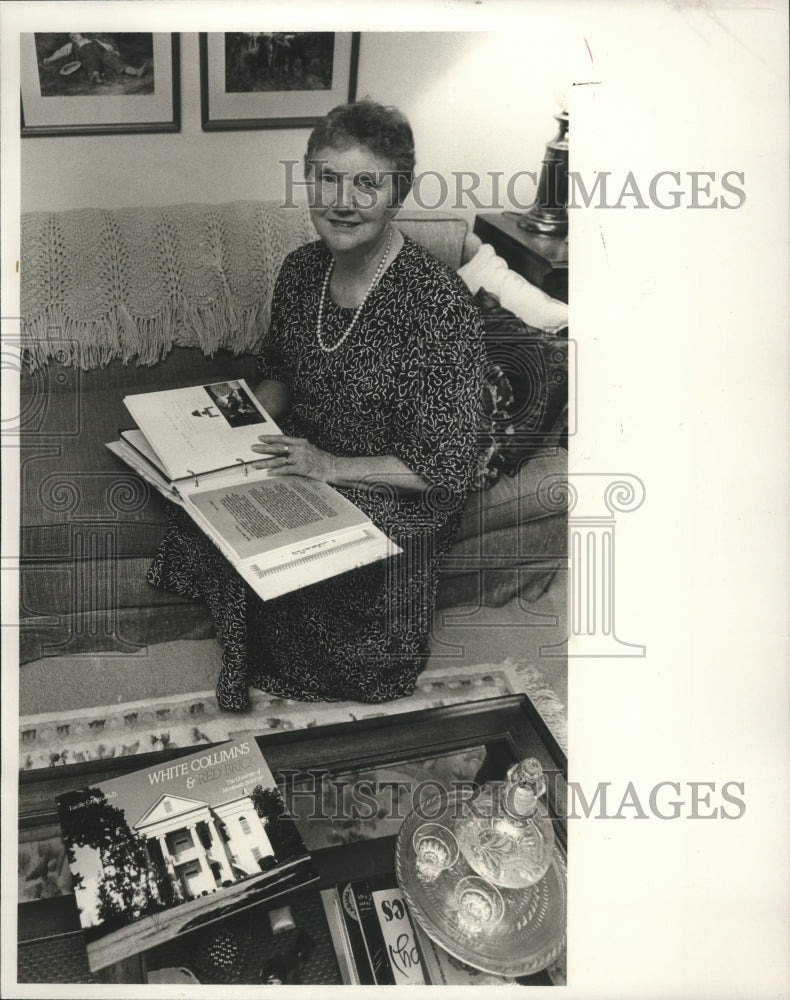 1989 Kathryn Tuner of University of Montevallo looks at scrapbook - Historic Images