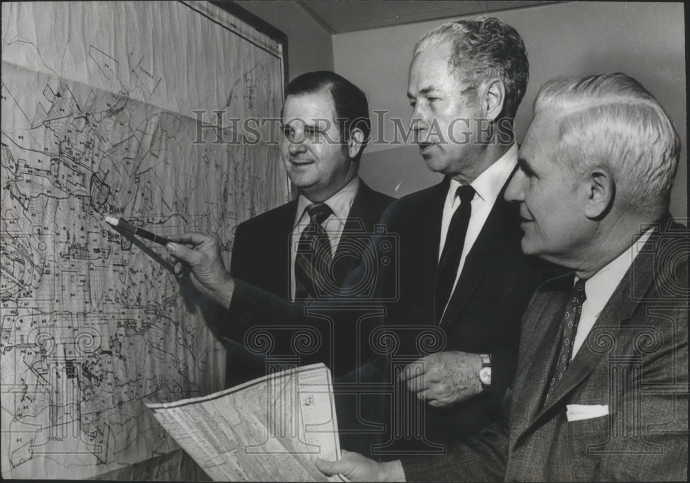 1970 SBA&#39;s Regional Director, city officials check flood damage map - Historic Images