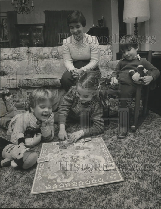 1984, Lynne Dickinson and her kids, Nathan, William, Jennifer play - Historic Images