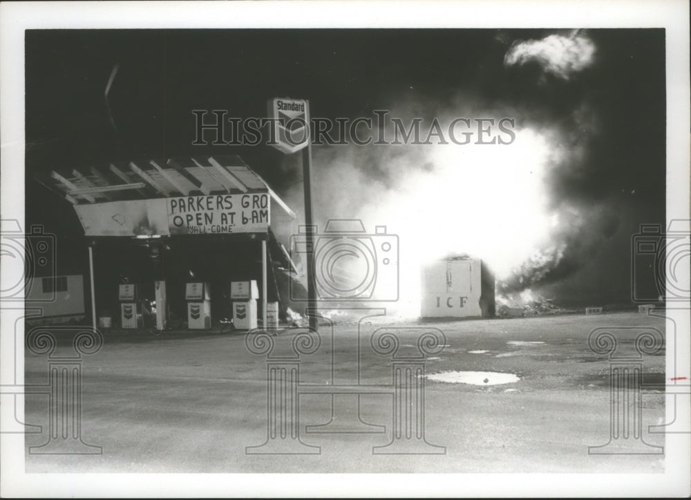 1976 Fire flared up, above, at Parker's Grocery and Service Station - Historic Images
