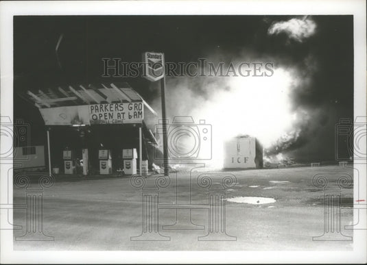 1976 Fire flared up, above, at Parker's Grocery and Service Station - Historic Images