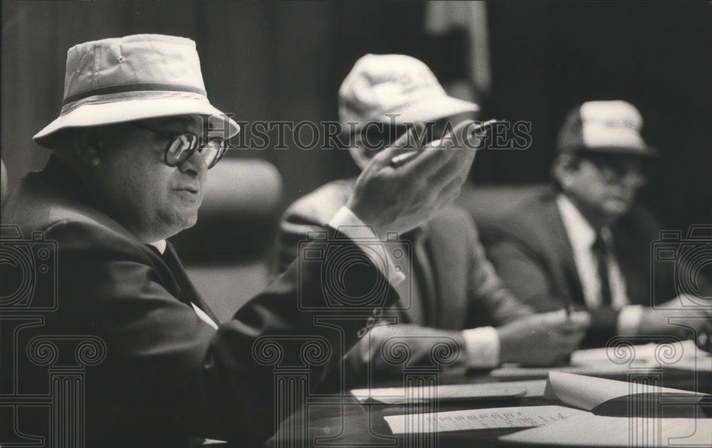 1985 Commission President Chriss Doss with Others wearing hats - Historic Images