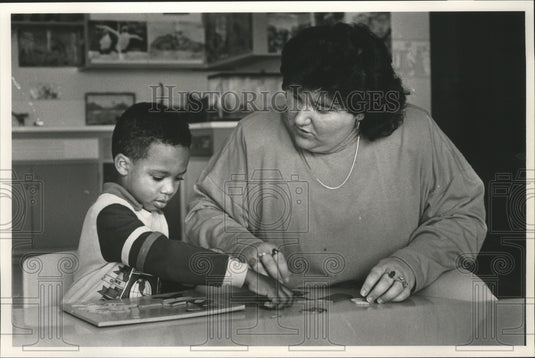 1991, Marsha Sims helps student David Thompson at Hobbs Elementary - Historic Images