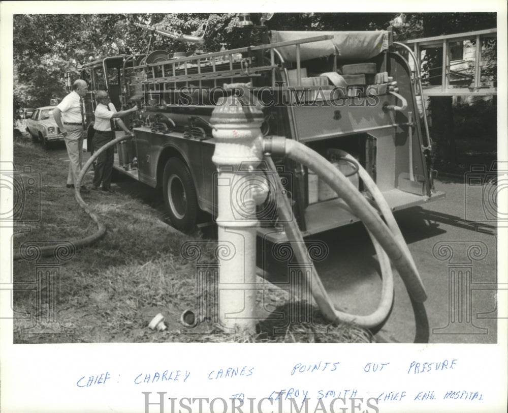 1979, Chief Charley Carnes shows water pressure to Leroy Smith - Historic Images