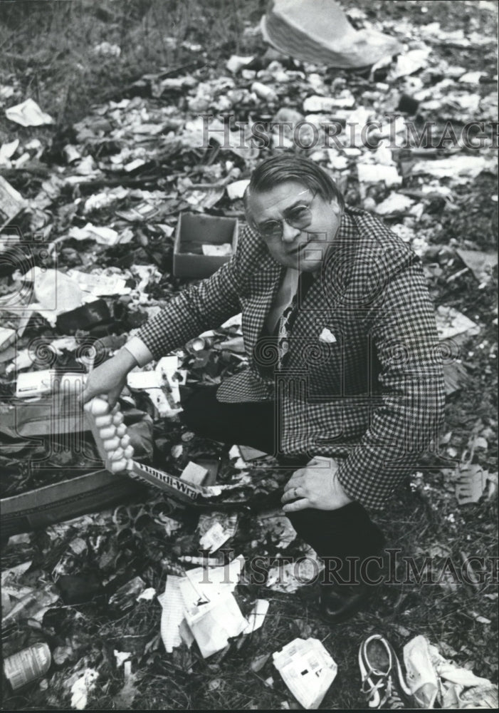 1979, Jefferson County Commissioner Chris Doss samples garbage - Historic Images