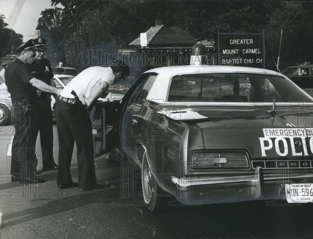1973, Birmingham Detective Higgins looks inside patrol car - Historic Images