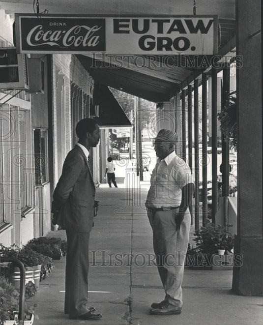 1983 Rev. Thomas Gilmore chats with parishioner Luther "Kitty" Means - Historic Images
