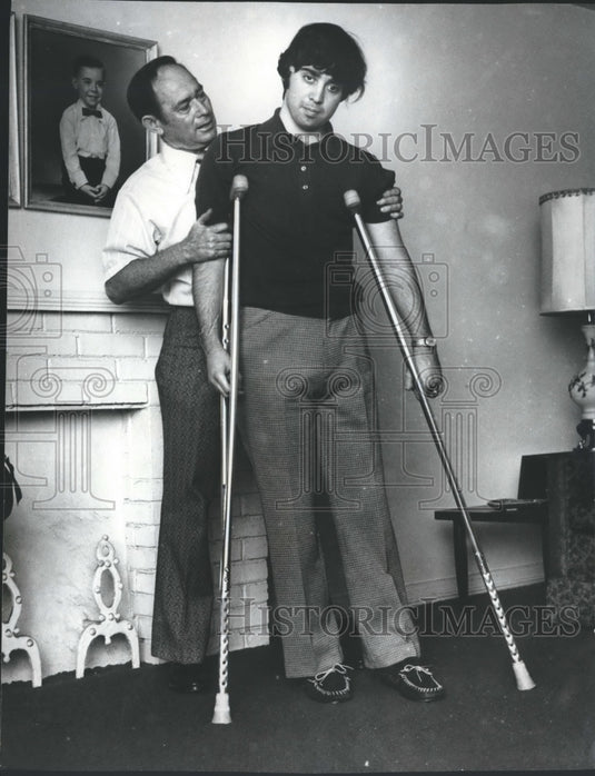 1972, Mike Golden on crutches after accident, with his dad, Doug - Historic Images
