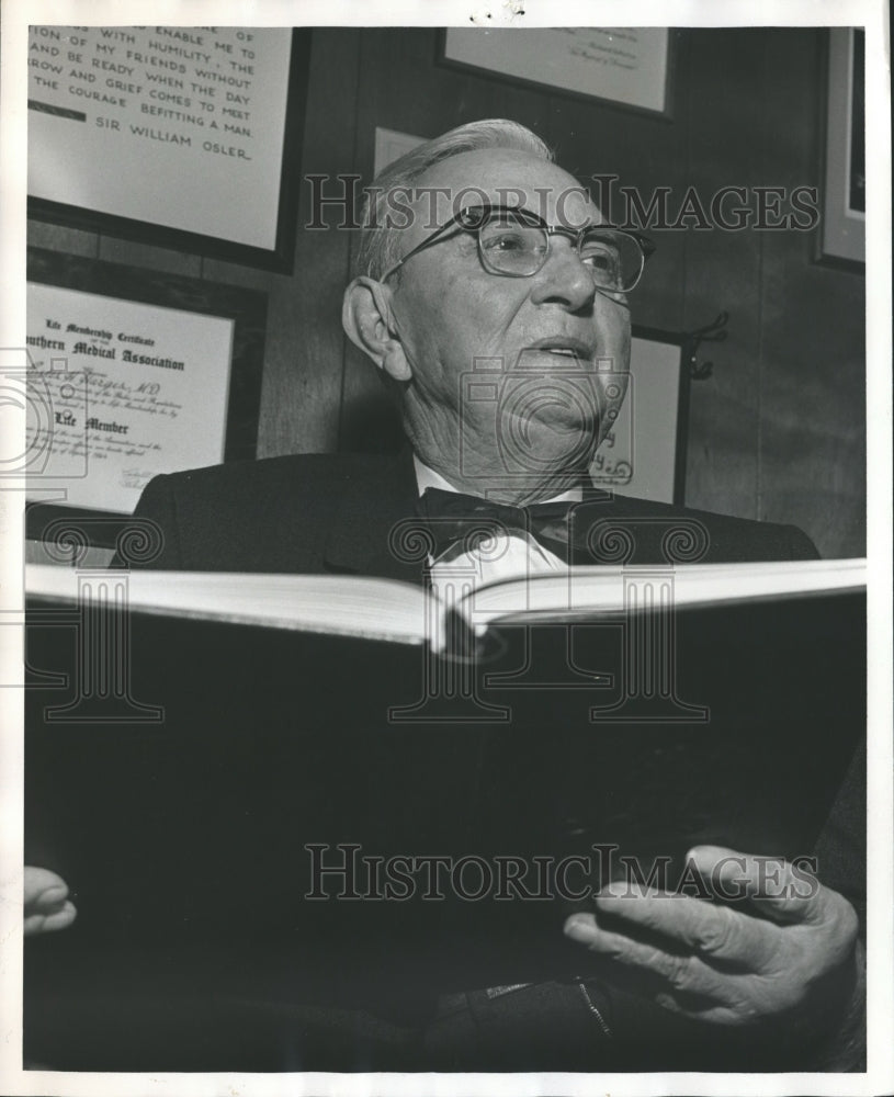 1966, Doctor Estes H. Hargis, holding book - abna30977 - Historic Images