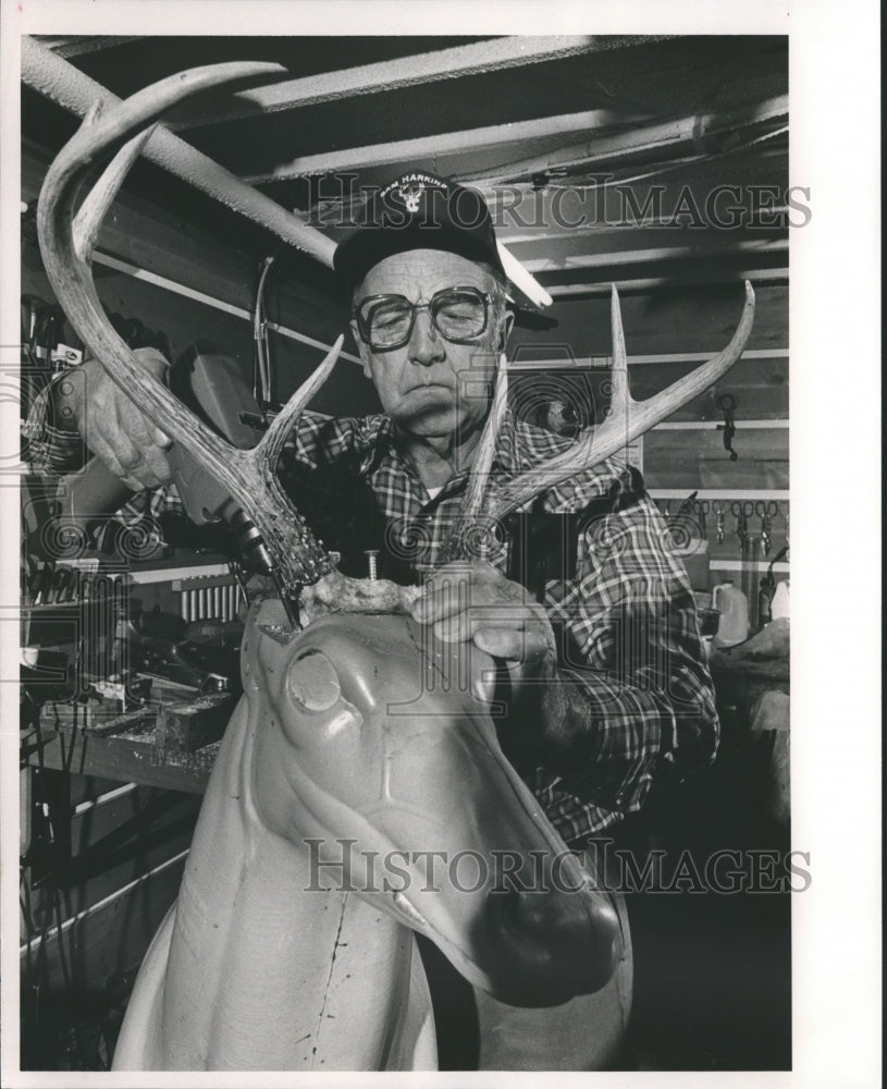 1990, Taxidermist Sam Harkins mounting antlers on form with screws - Historic Images
