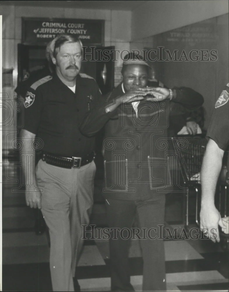 1980, Tommy Hines with deputy leaving Court room, Jefferson County - Historic Images