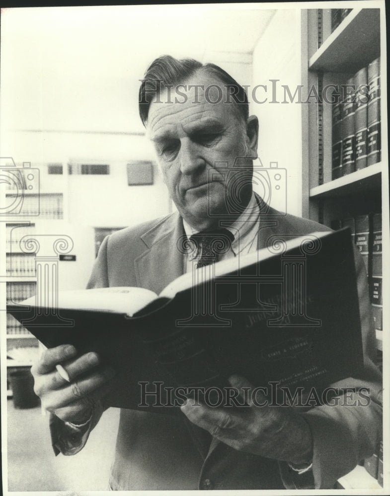 1980, Federal judge nominee Truman Hobbs reads law book - abna32635 - Historic Images