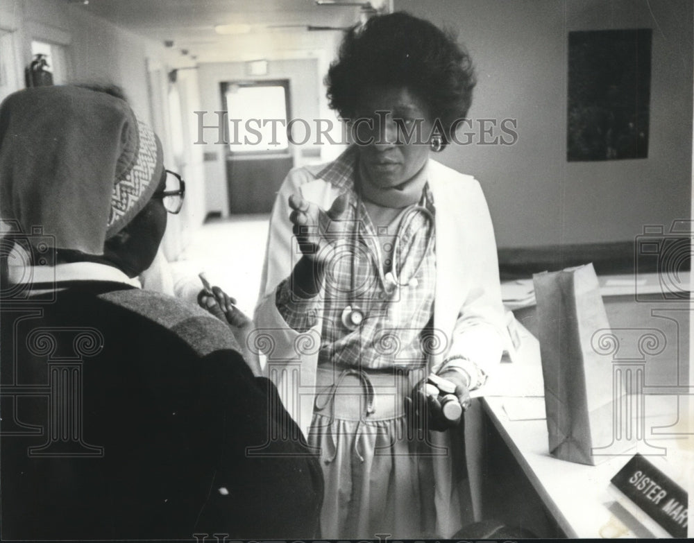 1978, Mrs. Stella Hyatt, Nurse Practitioner talks over problem - Historic Images