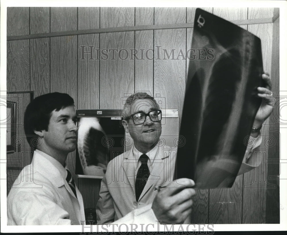 1979 Doctor Thomas James inspects an X-ray with Doctor Ben Thompson - Historic Images