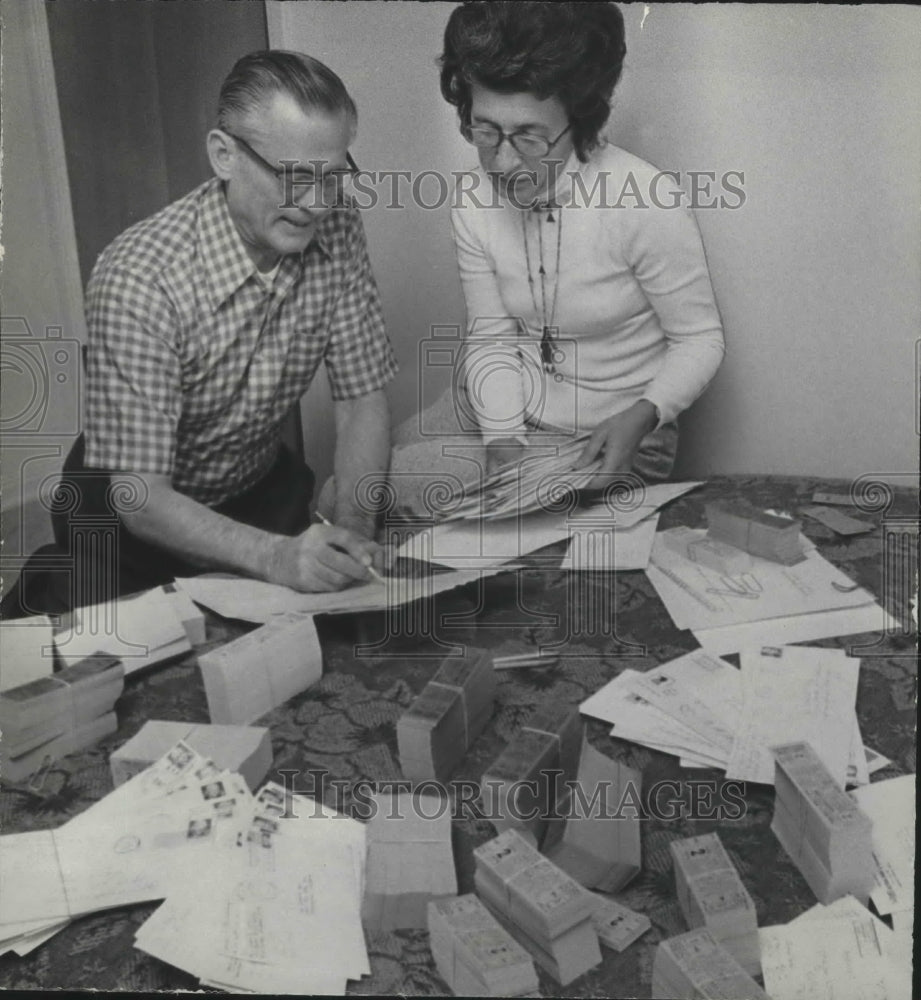 1974, Doctor and Mrs. Robert Day filling orders by Night for Game - Historic Images