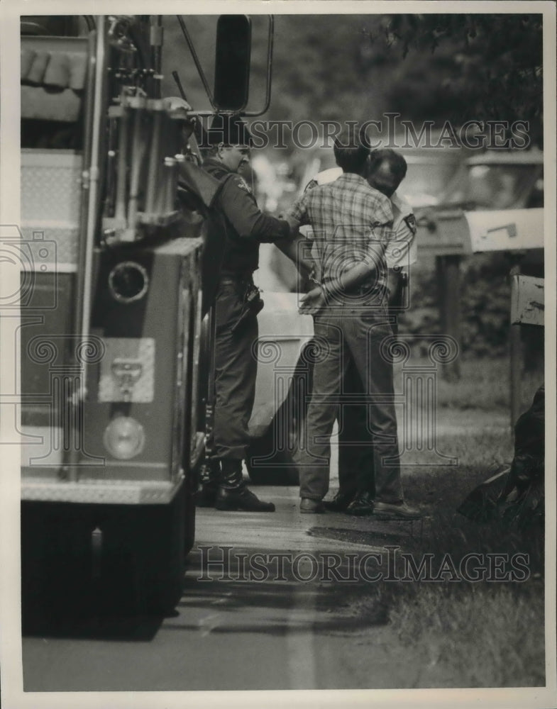 1985, Police Officers take Albert Cain into custody after fatal crime - Historic Images