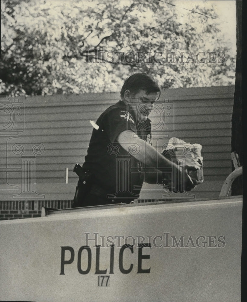 1976 Bomb Technician W. T. Landgraf carries dynamite from home - Historic Images