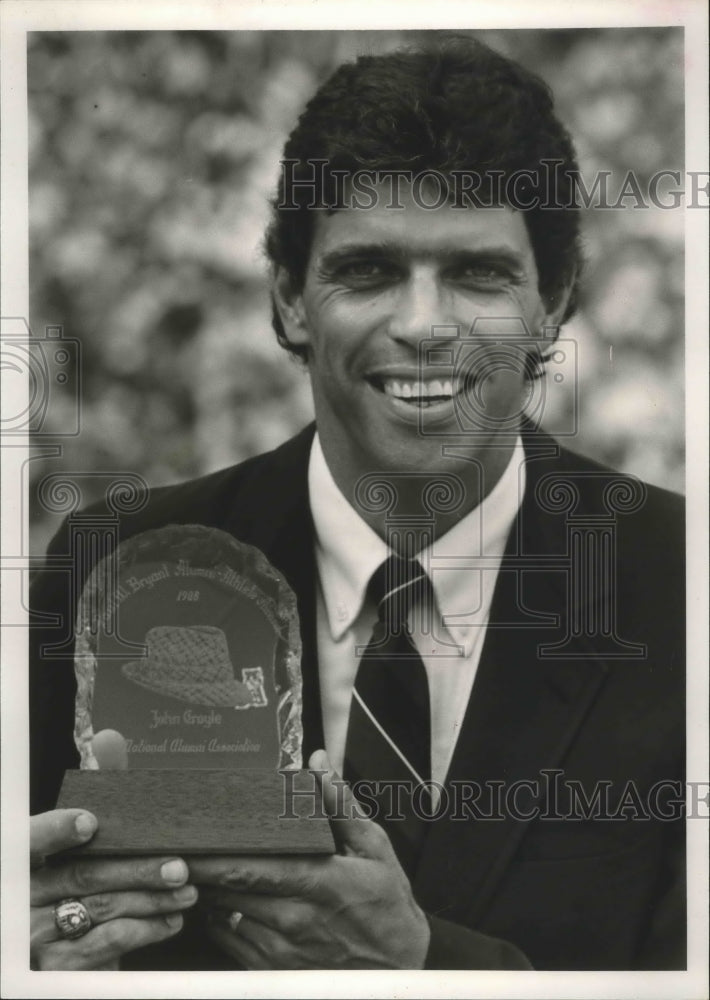 1988 John Croyle holds Bear Bryant Alumni Award - Historic Images