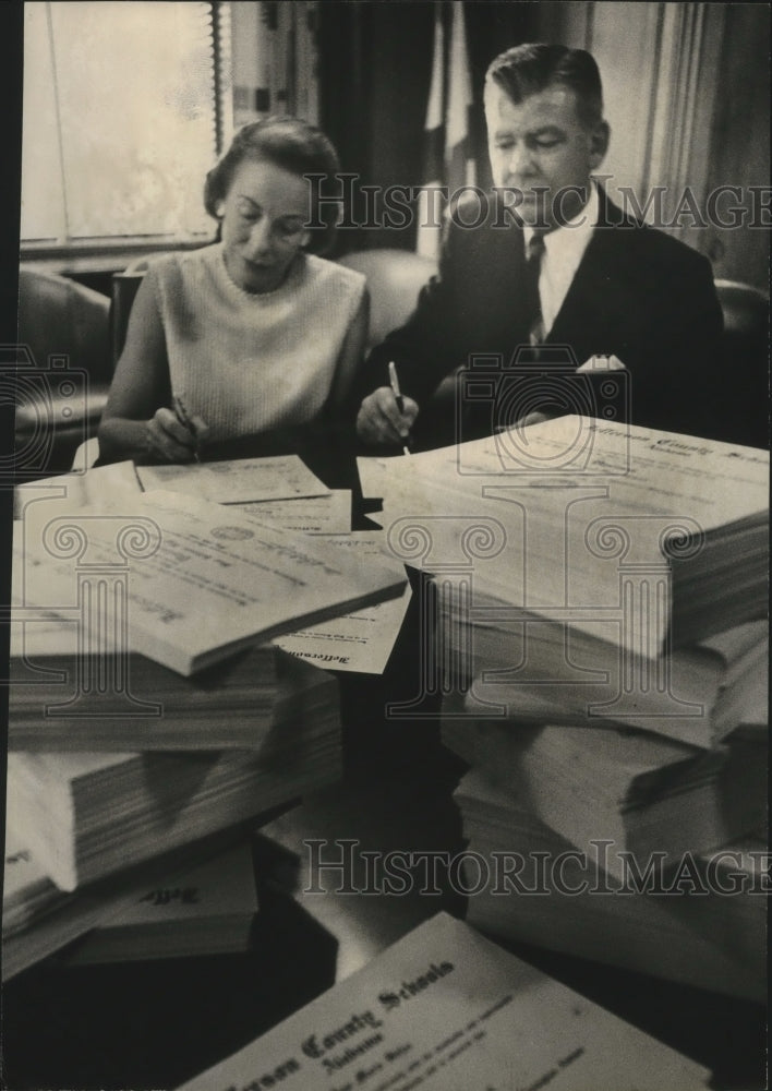 1964, Dr. Kermit Johnson and Mrs. Robert W. Gwin sign diplomas - Historic Images