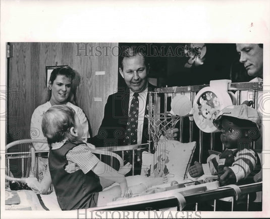 1990 Gubernatorial Candidate Paul Hubbert Visits Child in Hospital - Historic Images