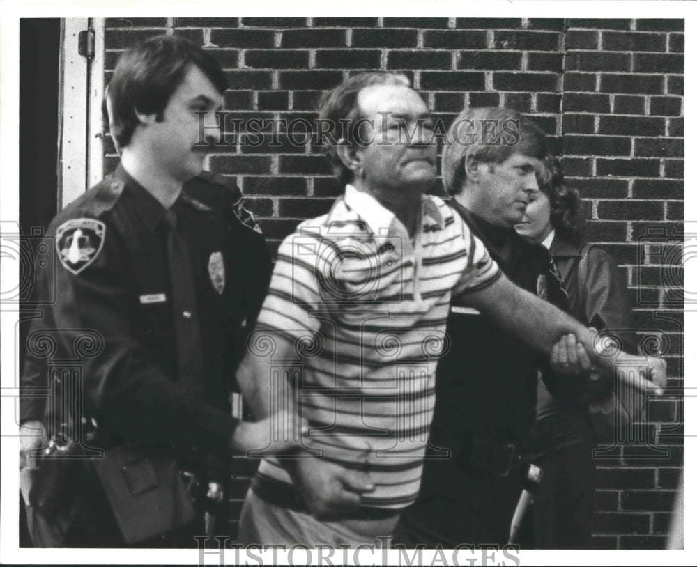 1981 Police escort Kenneth Harris from apartment - Historic Images