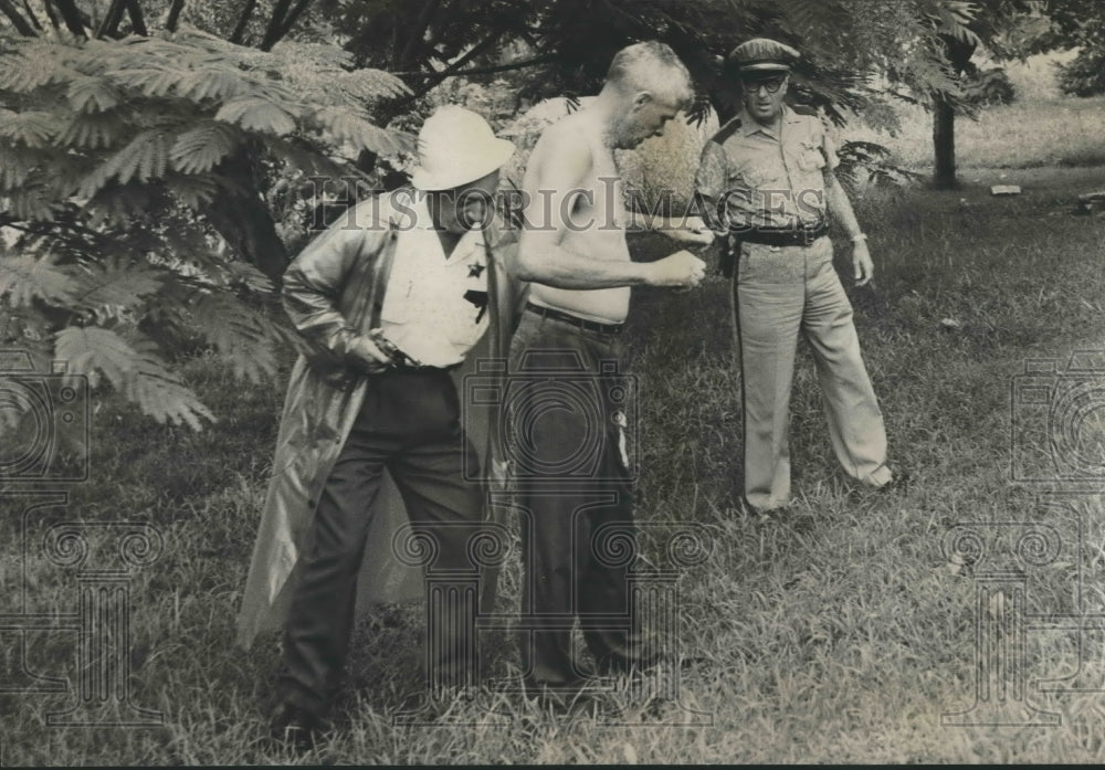 1963, Thomas Looney searched by police officers - abna35658 - Historic Images