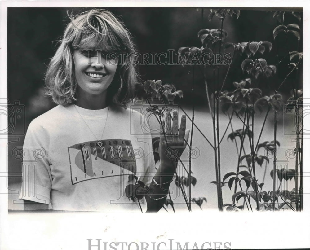 1990 Janet Joseph, Ryan White's aunt standing by plants - Historic Images