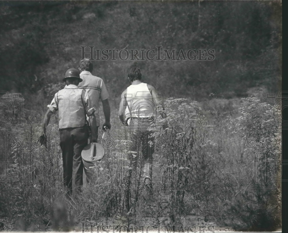 1982, Searchers in grassy area near Highway 50. - abna35745 - Historic Images