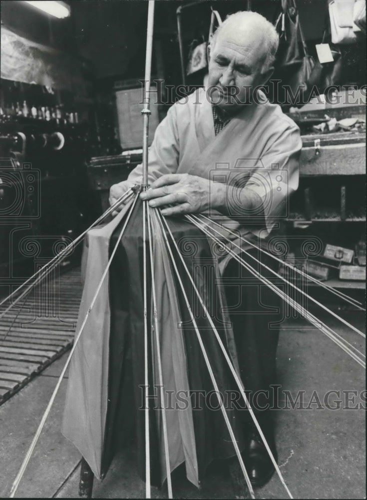 1978, Rocco Leo, Shoe Shop Owner repairs Umbrella in Shop - abna36083 - Historic Images