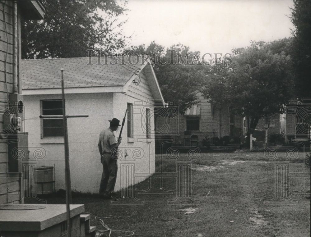 1969, officer taking cover during shootout with Charles Haygood - Historic Images