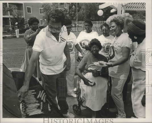 1989, Fairfield Mayor, Larry Langford cooks hot dogs for elderly, AL - Historic Images