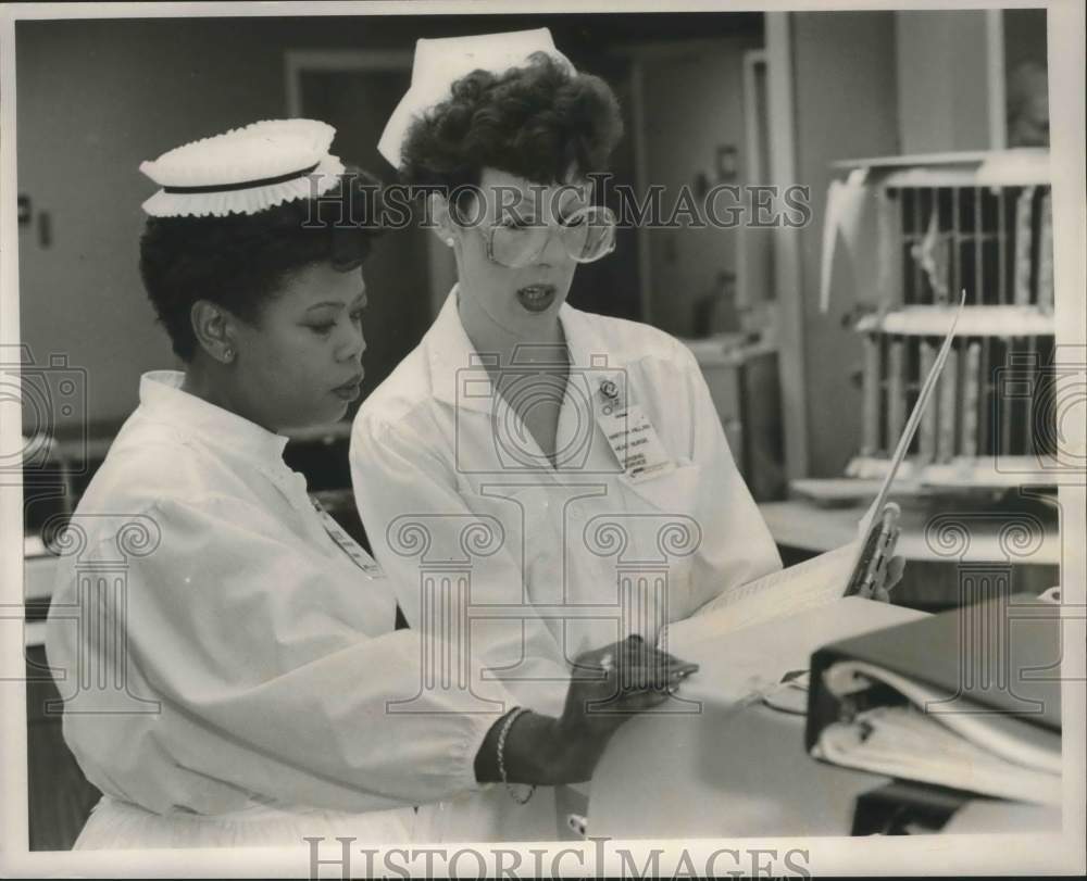 Press Photo Pearline Bell &amp; Martha Hill, nurses review records - abna37698 - Historic Images