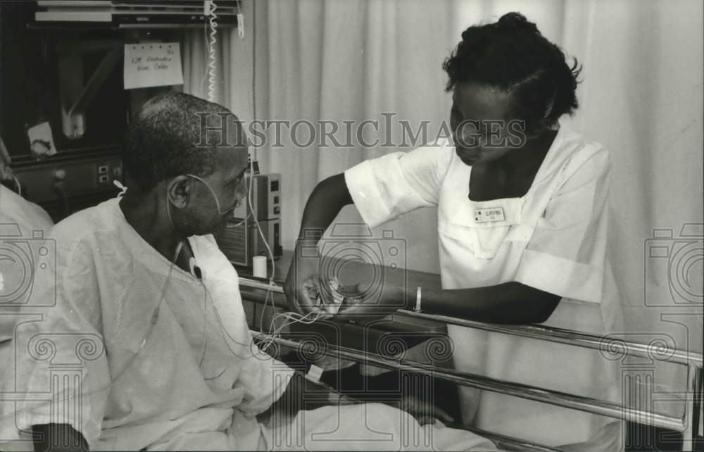 1980, RN Shevorn Porter Helps Patient Nathan Moore - abna37701 - Historic Images