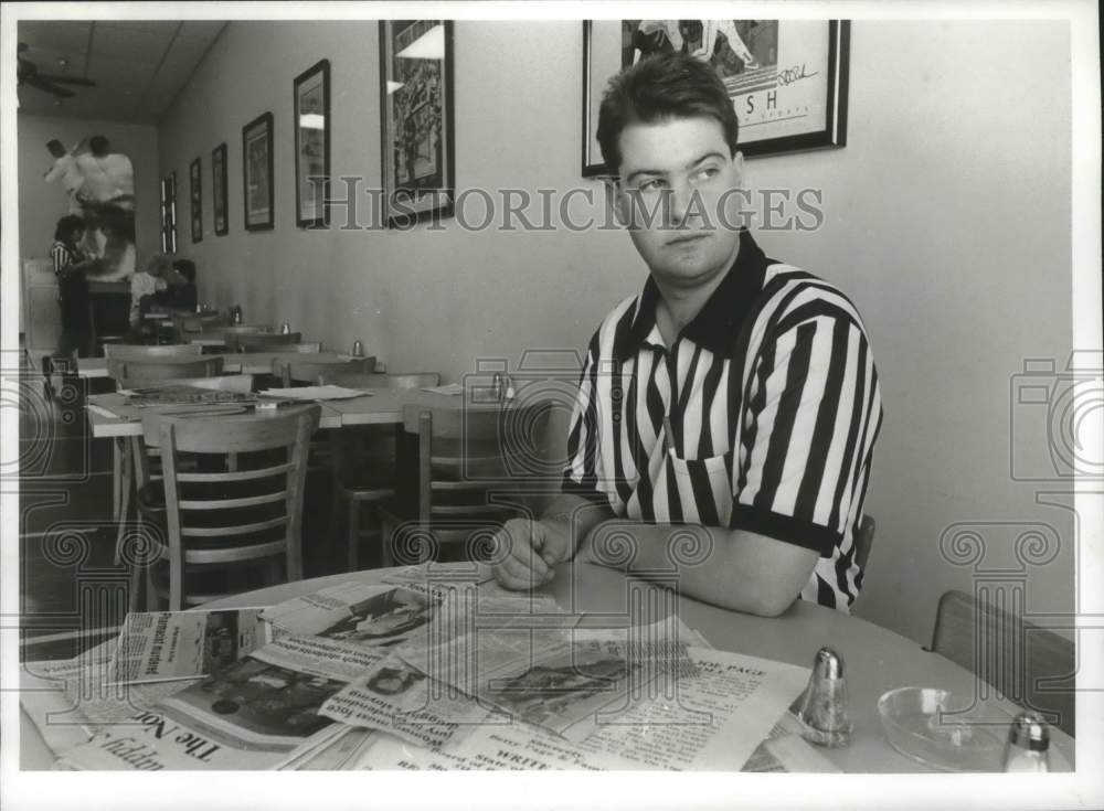 Press Photo Rodney Page Sits at Table Strewn With Clips on Dad's Murder - Historic Images