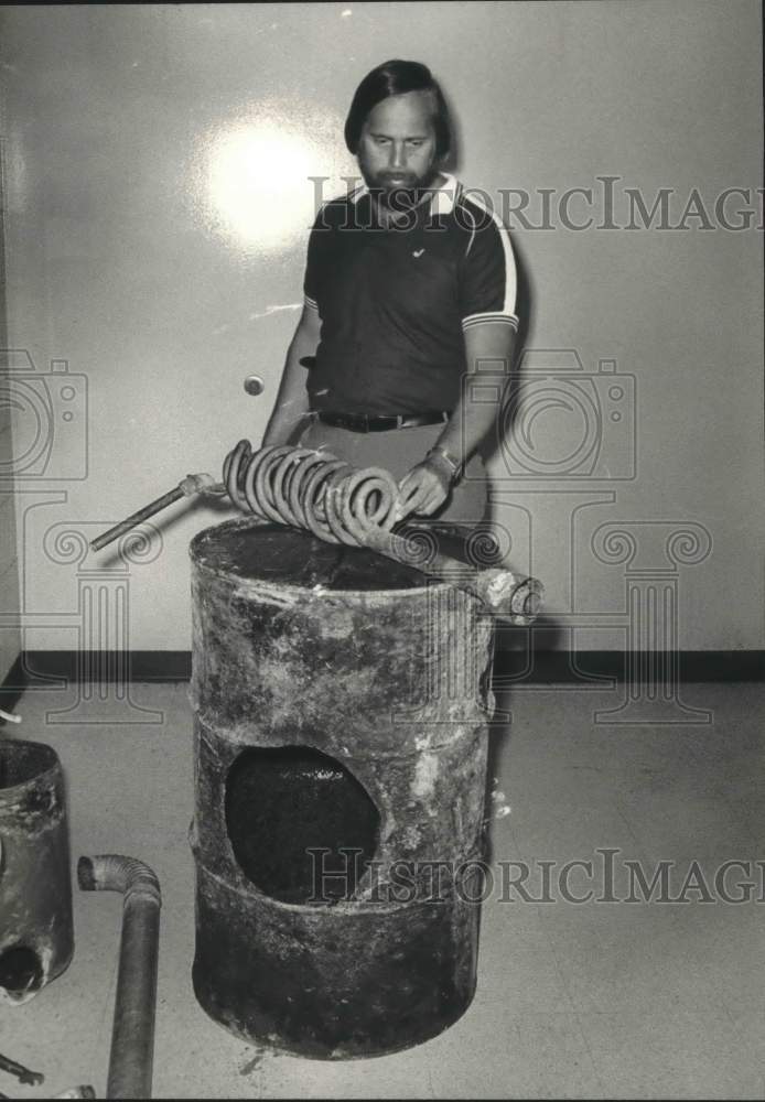 1987 Press Photo Lieutenant Charles H. Newfield Displays Confiscated Still - Historic Images