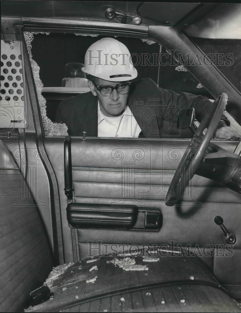 1973, James L. Robinson looks at vandalized police car, Birmingham - Historic Images